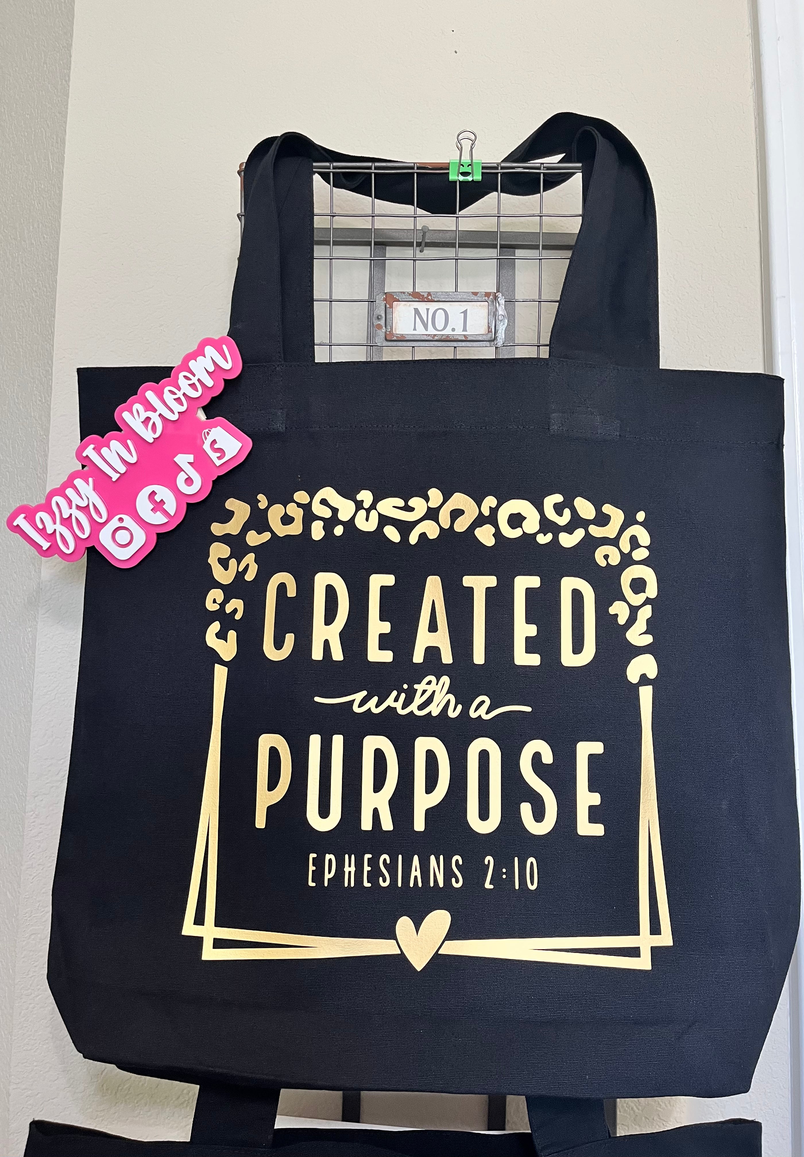 Black 16x15X3 100% Cotton Tote Bag featuring the message “Created With A Purpose” along with the Biblical Scripture Ephesians 2:10.