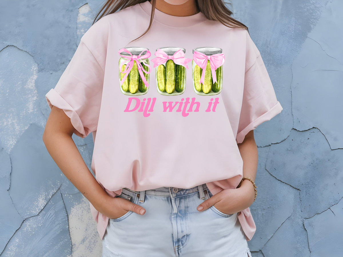 Pickle Inspired Woman’s T-Shirt Featuring Pink Coquette Bows, Pickles and Saying “Dill With It”.