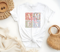 Faith Based Woman’s T-Shirt featuring a pink coquette bow with flower decor and the message “AMEN”