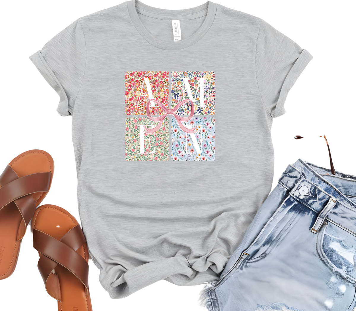 Faith Based Woman’s T-Shirt featuring a pink coquette bow with flower decor and the message “AMEN”