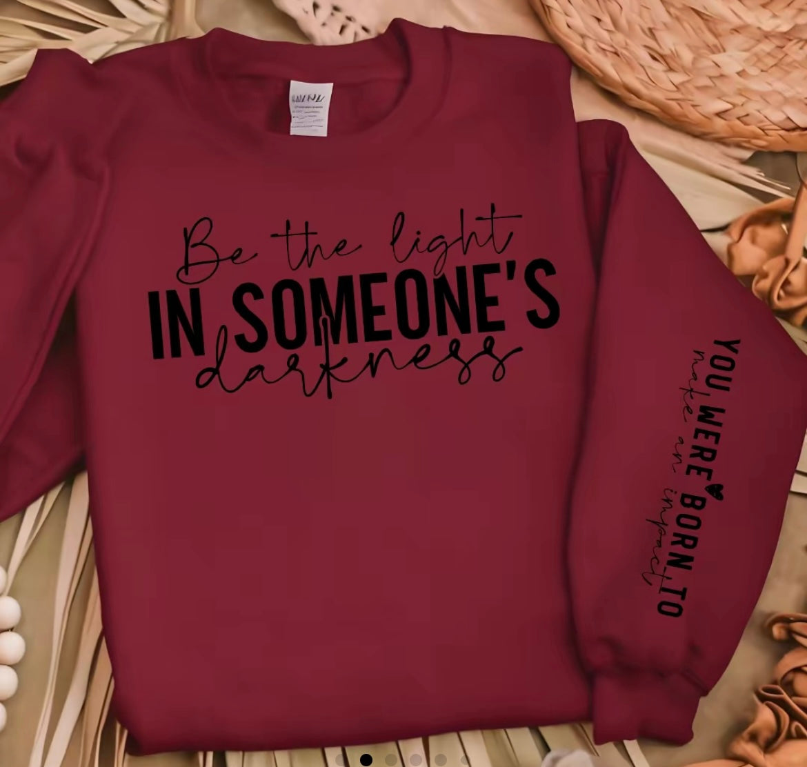Faith Based Crewneck Sweatshirt featuring the message “Be The Light In Someone’s Darkness, You Were Born To Make An Impact”