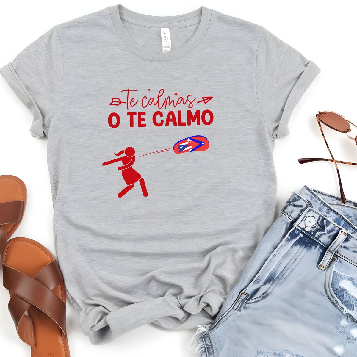 Puerto Rican Chancla Themed Woman’s T-Shirt featuring, a Spanish message “Te Calmas O Te Calmo” with a graphic picture of a mom throwing a flip flop/chancla in Spanish.