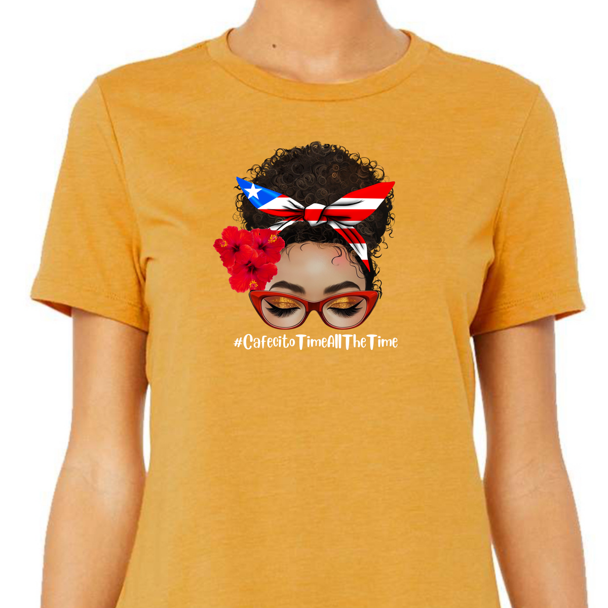 Latina Inspired Woman’s T-Shirt featuring “An Afro Latina messy bun face with curly hair wearing a Puerto Rican inspired Headband, Hibiscus Flowers on her right ear and Red cat eye glasses” with the hash tag “Cafecito Time All The Time”.