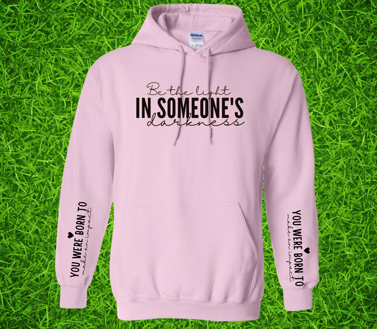 Faith Based Woman’s Hoodie, with the front message, "Be the Light In Someone's Darkness," and the empowering sleeve message, "You Were Born To Make An Impact," (Sleeve print can go on L or R sleeve.)
