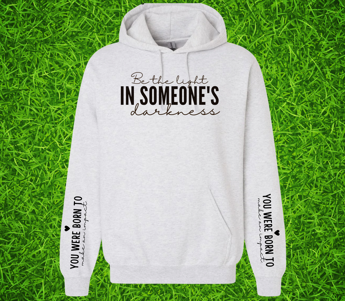 Faith Based Woman’s Hoodie, with the front message, "Be the Light In Someone's Darkness," and the empowering sleeve message, "You Were Born To Make An Impact," (Sleeve print can go on L or R sleeve.)