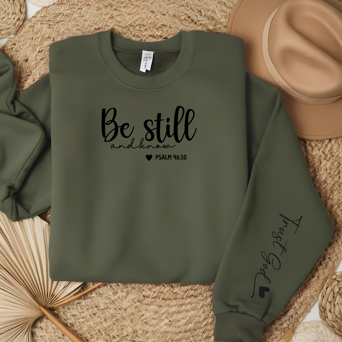 Faith Based Crewneck Sweatshirt featuring the message “Be Still and Know” and a sleeve message “Trust God” with the bible verse Psalm 46:10.